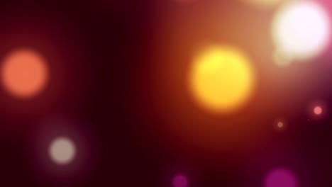 animation of multi coloured glowing spots of light moving in hypnotic motion on background