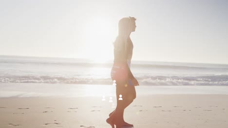 animation of multiple profile icons floating over caucasian couple walking together at the beach