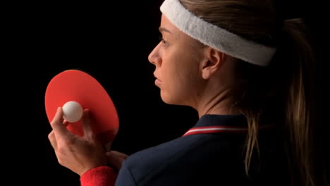 Female-ping-pong-player-holding-ball-and-racket