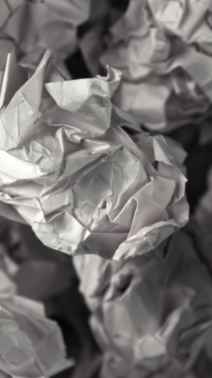 Pile of Crumpled White Paper Balls Coming into Focus