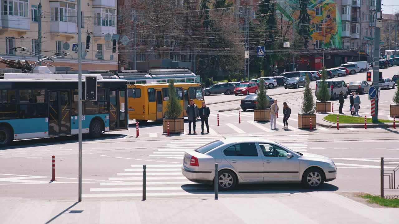 Pedestrians cross the street. Group of friends crossing the street