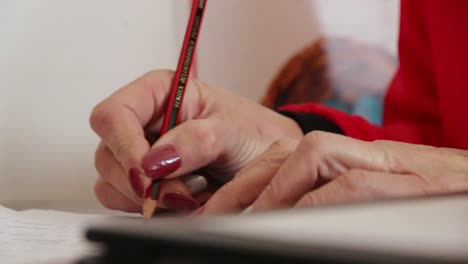 woman writing with pencil in a book