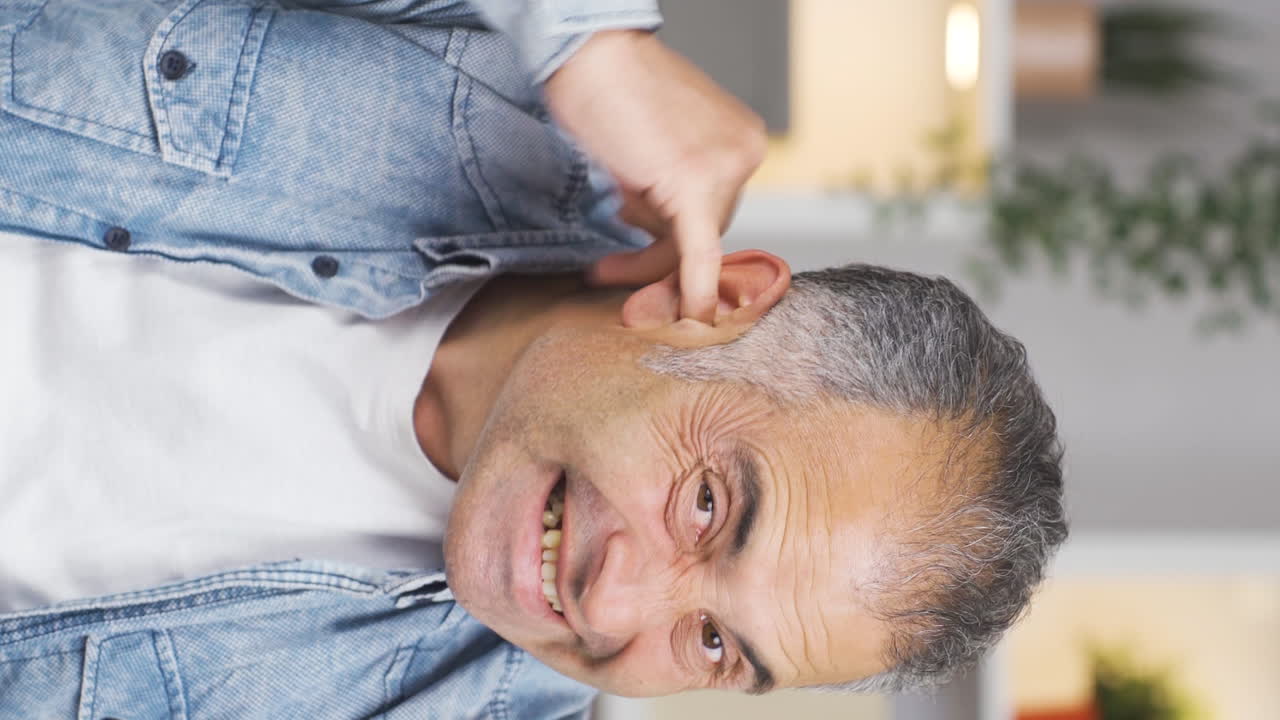 Vertical video of Man with itchy ears.
