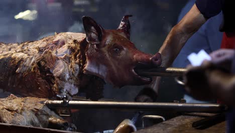 street food. pork being cooked over a hot charcoal fire