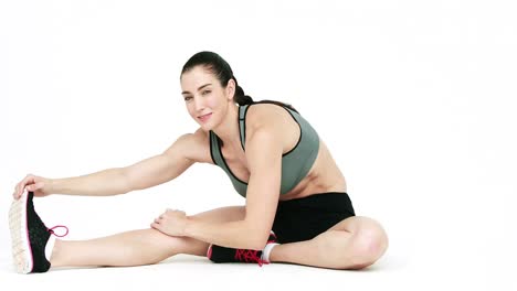 Smiling-athlete-stretching-legs