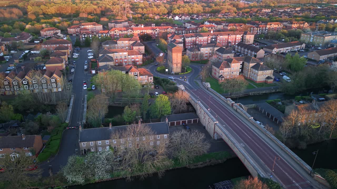 Aerial view over Enfield island water tower in evening sunlit modern London property neighbourhood