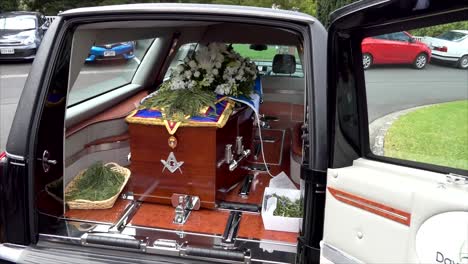 closeup shot of a funeral casket in a hearse or chapel or burial at cemetery