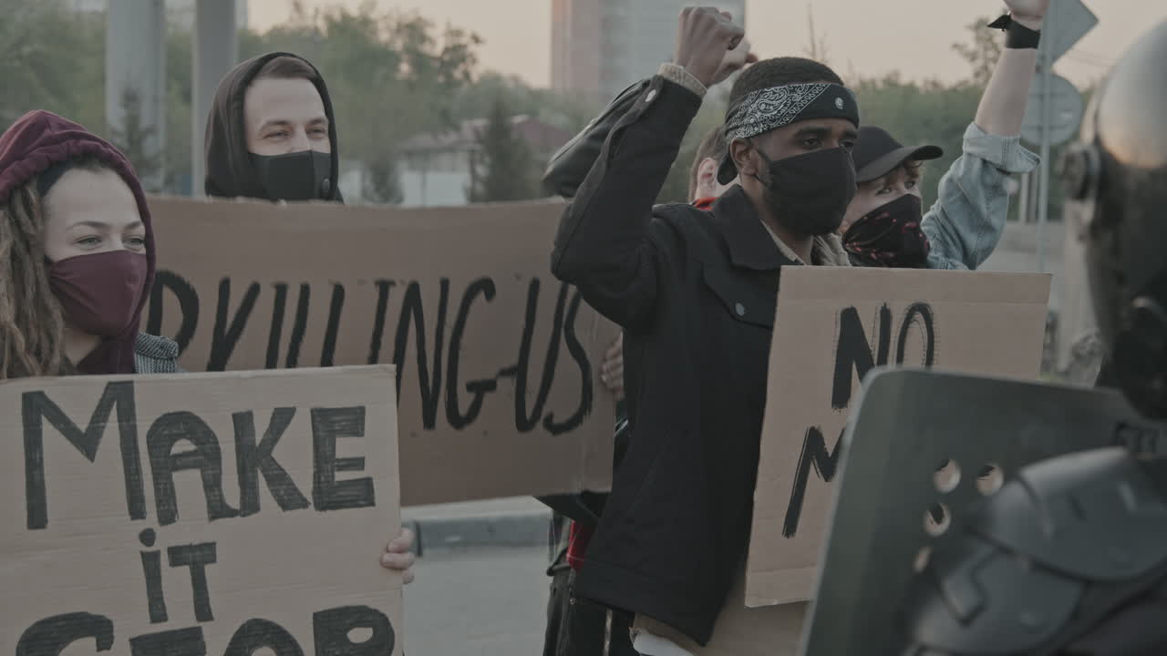 Protest with signs against police and social issues