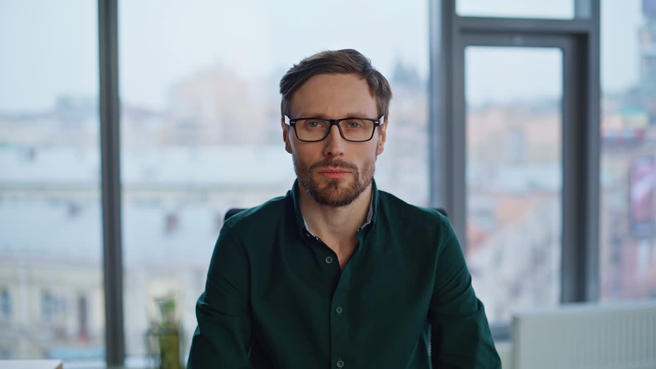 Portrait friendly entrepreneur pointing finger to camera at contemporary office