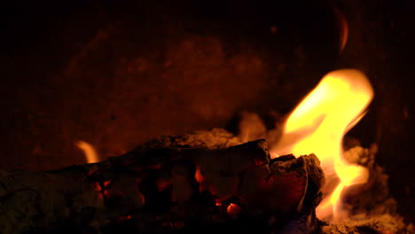 an out of focus flaming log coming into focus with beautiful yellow orange flames.