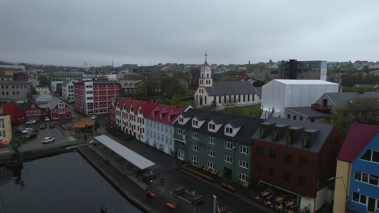 Drone view of the colorful houses and the Cathedral of Torshavn on a cloudy day