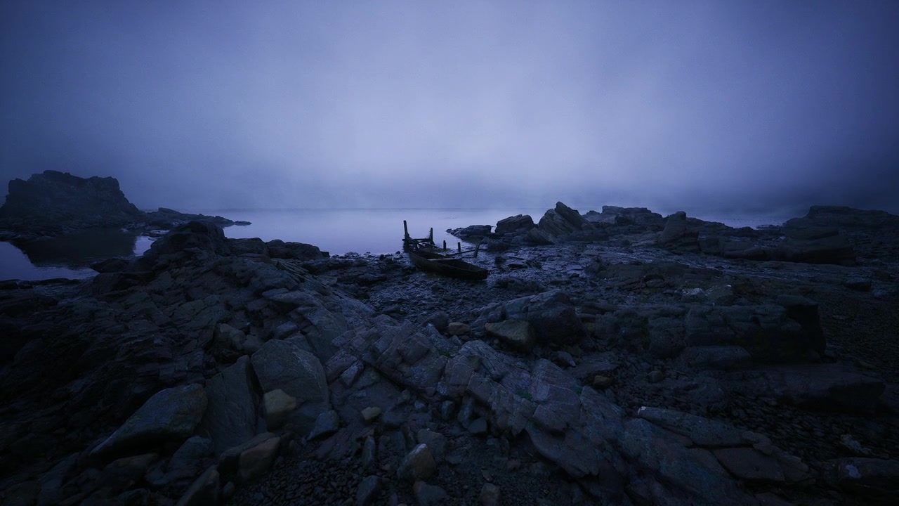Serene blue horizon scene calm coastal scene with fog and rocks