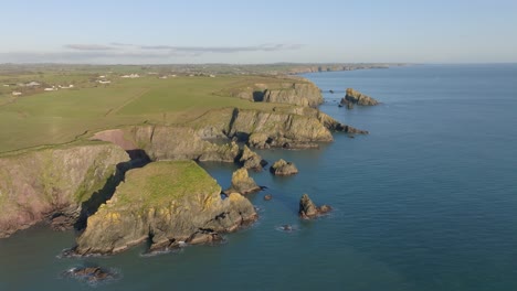 drone flight over sea sea stacks and hidden coves coastline at copper coast waterford ireland