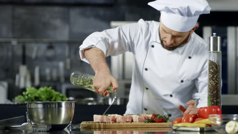 portrait of chef cooking raw steak in kitchen