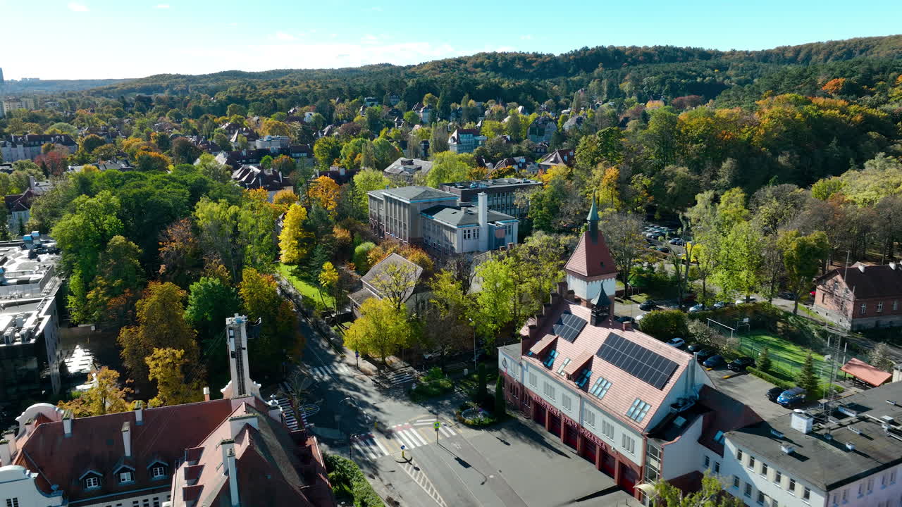 Aerial view of Sopot residential district surrounded by autumn forest and hills, showing mix of houses and greenery - Faculty of Management University of Gdańsk