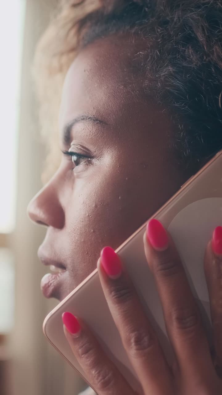 Young african american woman millennial holding mobile phone to ear and talking