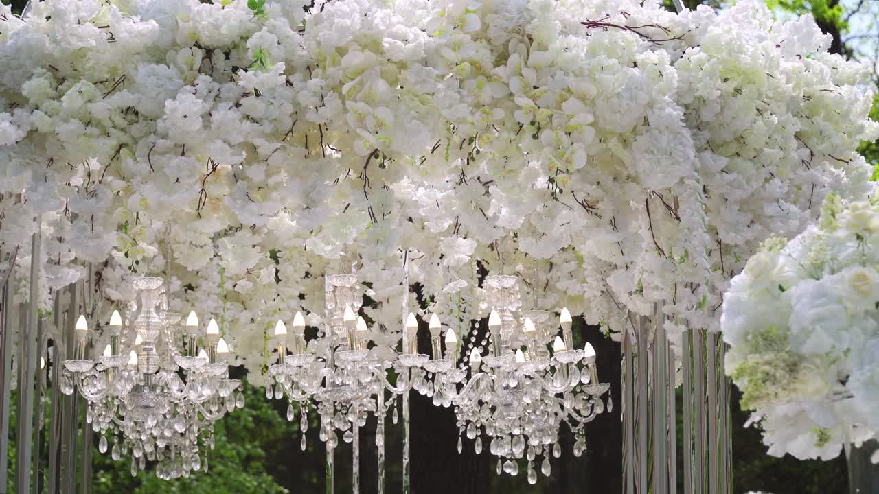 White wedding arch with chandeliers and candles 04