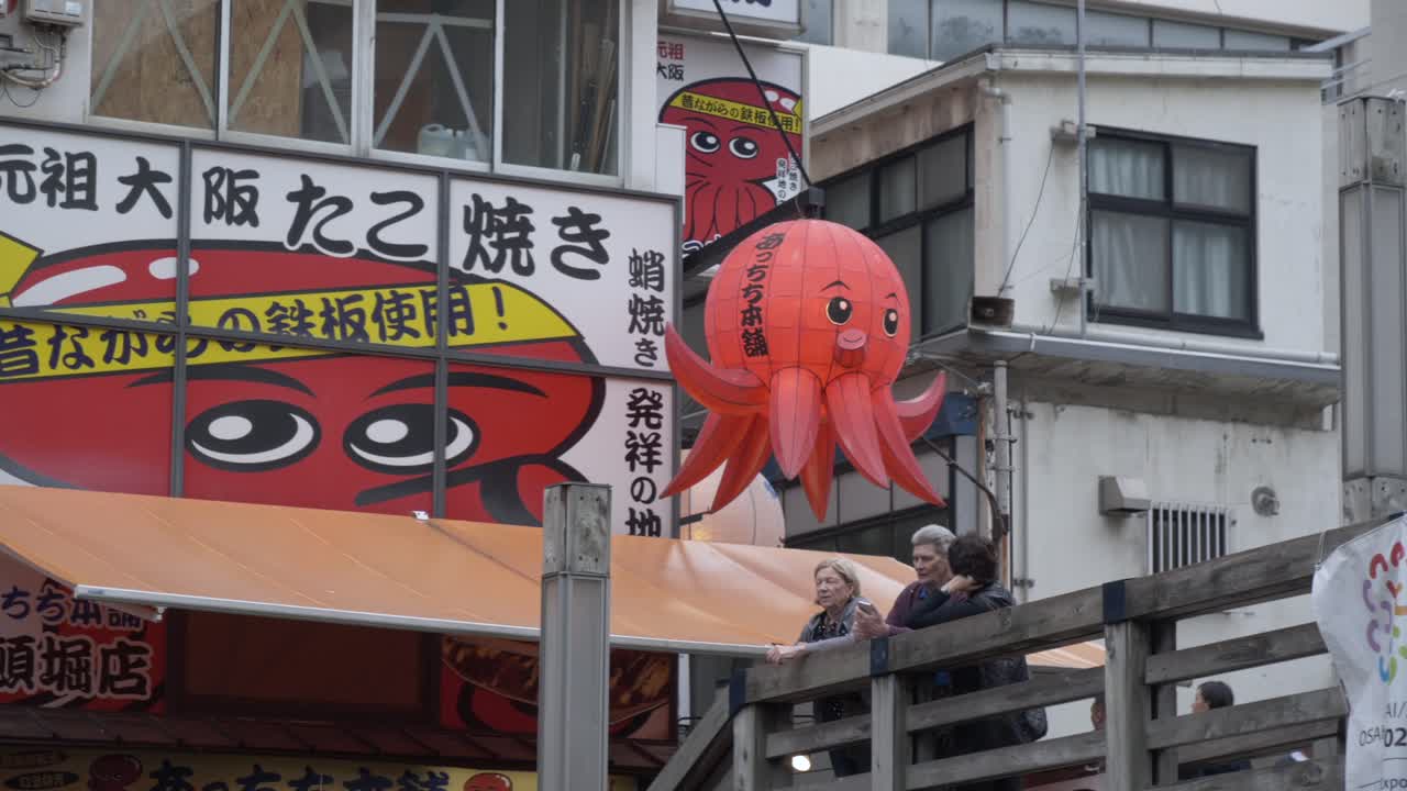 Dotonbori street scene with Takoyaki octopus lantern and people in Osaka, Japan