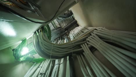 organized network of electrical conduits and cables in utility room