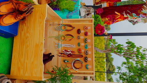 Wooden-trunk-with-earrings,-necklaces-and-shoes-in-a-hippie-outdoor-market