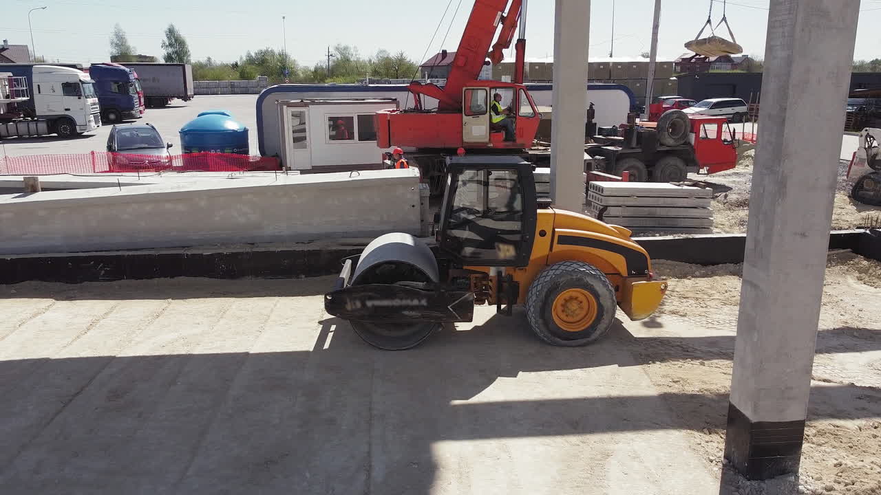 Construction Site with Road Roller and Crane