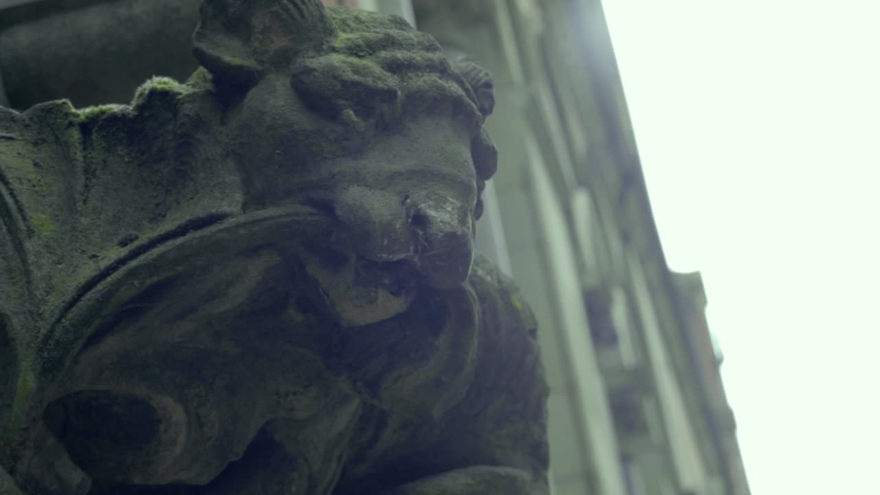 Stone gargoyle on the side of old court building in Manchester UK-1