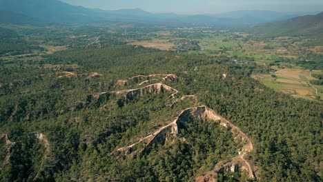 aerial scenic drone footage of a canyon in the town of pai, thailand on a sunny day
