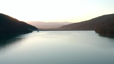 aerial view of frumoasa dam during sunset, romania