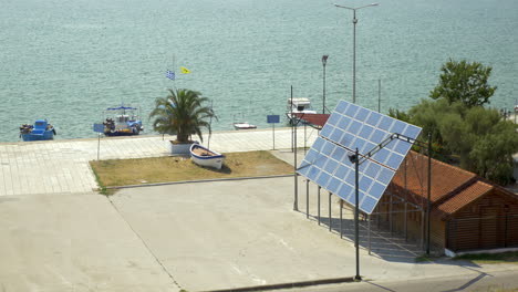 solar panels are fixed next to the house in the background is a calm sea