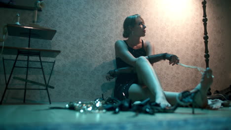 woman in retro dress sitting on floor