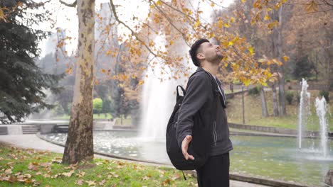 Happy-male-finds-peace-and-refreshes-in-nature-park.