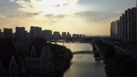 Dramatic-afternoon-lighting:-Aerial-along-scenic-canal-in-Suzhou-China