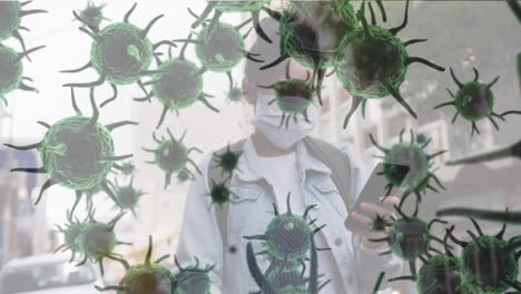 animation of macro coronavirus covid-19 cells spreading over woman wearing a face mask