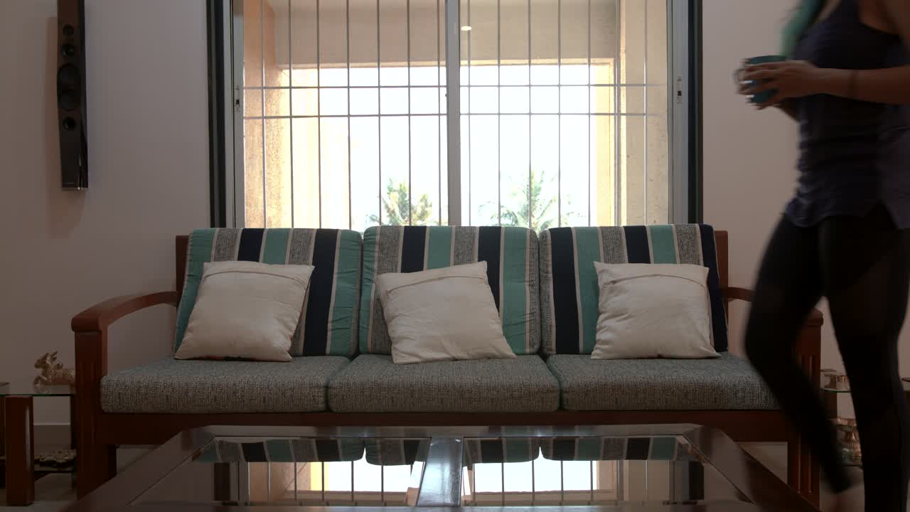 Indian Woman sitting down with tea and beagle asking for a walk