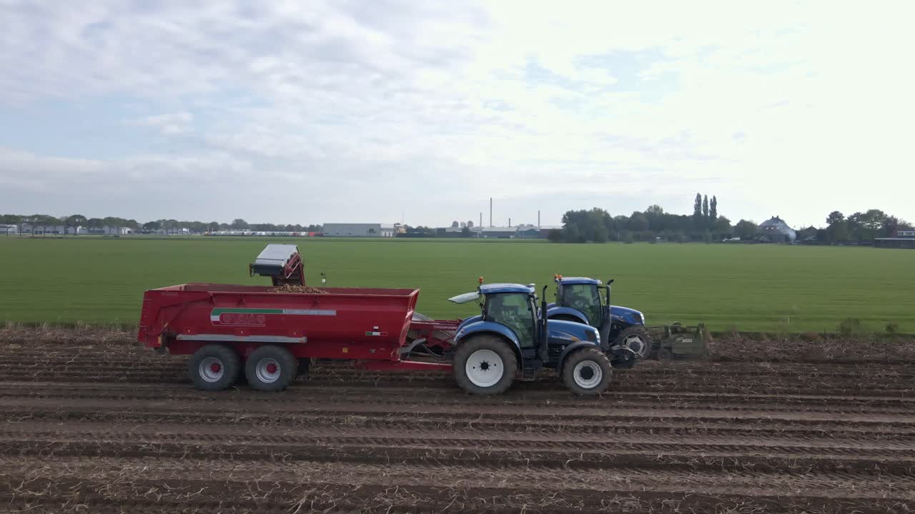 감자 측경을 수확하는 트랙터에 있는 농부들의 공중