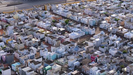 small tombstone homes in cemetery organized in clean rows of crypts in curacao