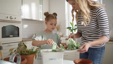 video of mother and daughter doing compost at home