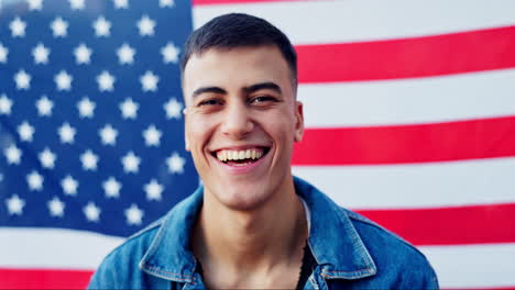 man smiling in front of american flag
