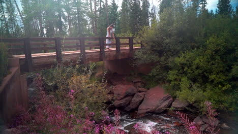 cinematic female women actress model close up standing on bridge above flowing river blue denver vail piney ranch beaver creek avon gore range scenic mountain landscape gold hour light adventure