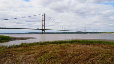 aerial drone scene: humber bridge, 12th largest suspension span globally, over river humber, connecting lincolnshire to humberside amidst traffic