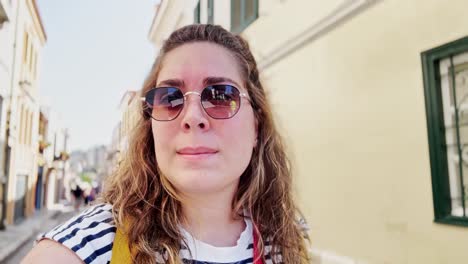 thoughtful woman exploring a colorful street in greece