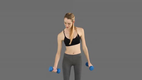 Fit-model-lifting-dumbbells