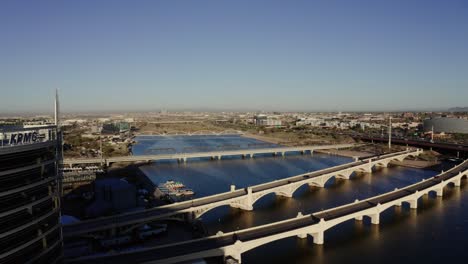 drone shot of bridges passing over the tempe town lake in arizona
