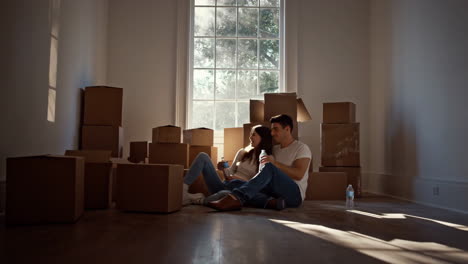 couple relaxing in their new home amidst moving boxes
