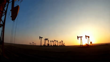 oil pump jack maintenance at sunset
