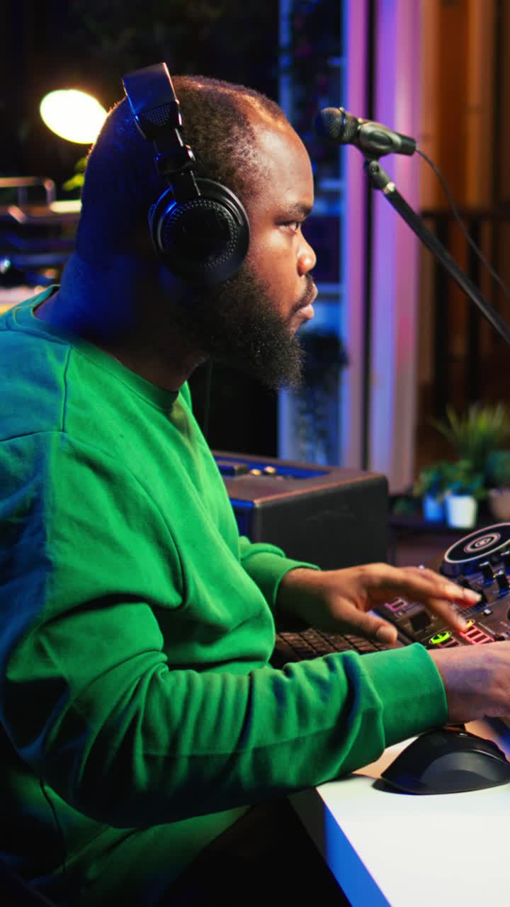 African American Man Wearing Headphones and Using Sound Mixer in Studio