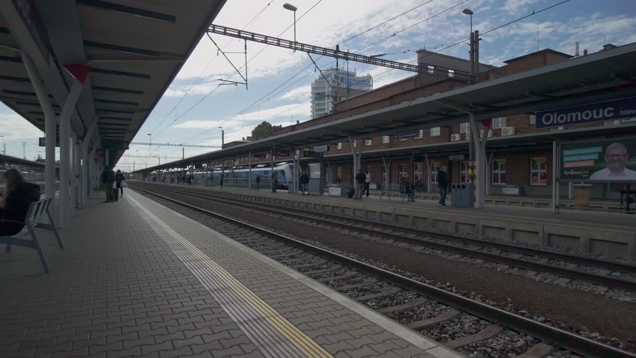 City train station platform, passengers waiting, urban transportation