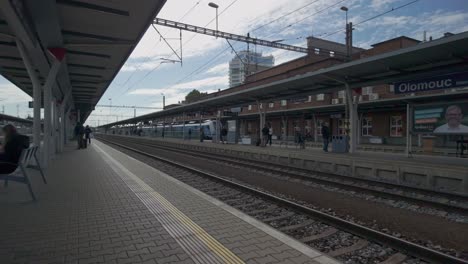 city train station platform, passengers waiting, urban transportation