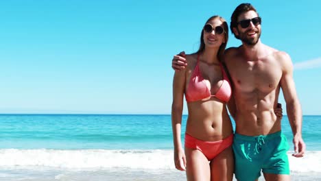 Young-couple-walking-on-beach