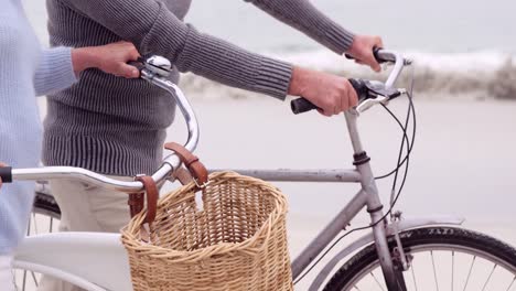 mid section of mature couple on bikes